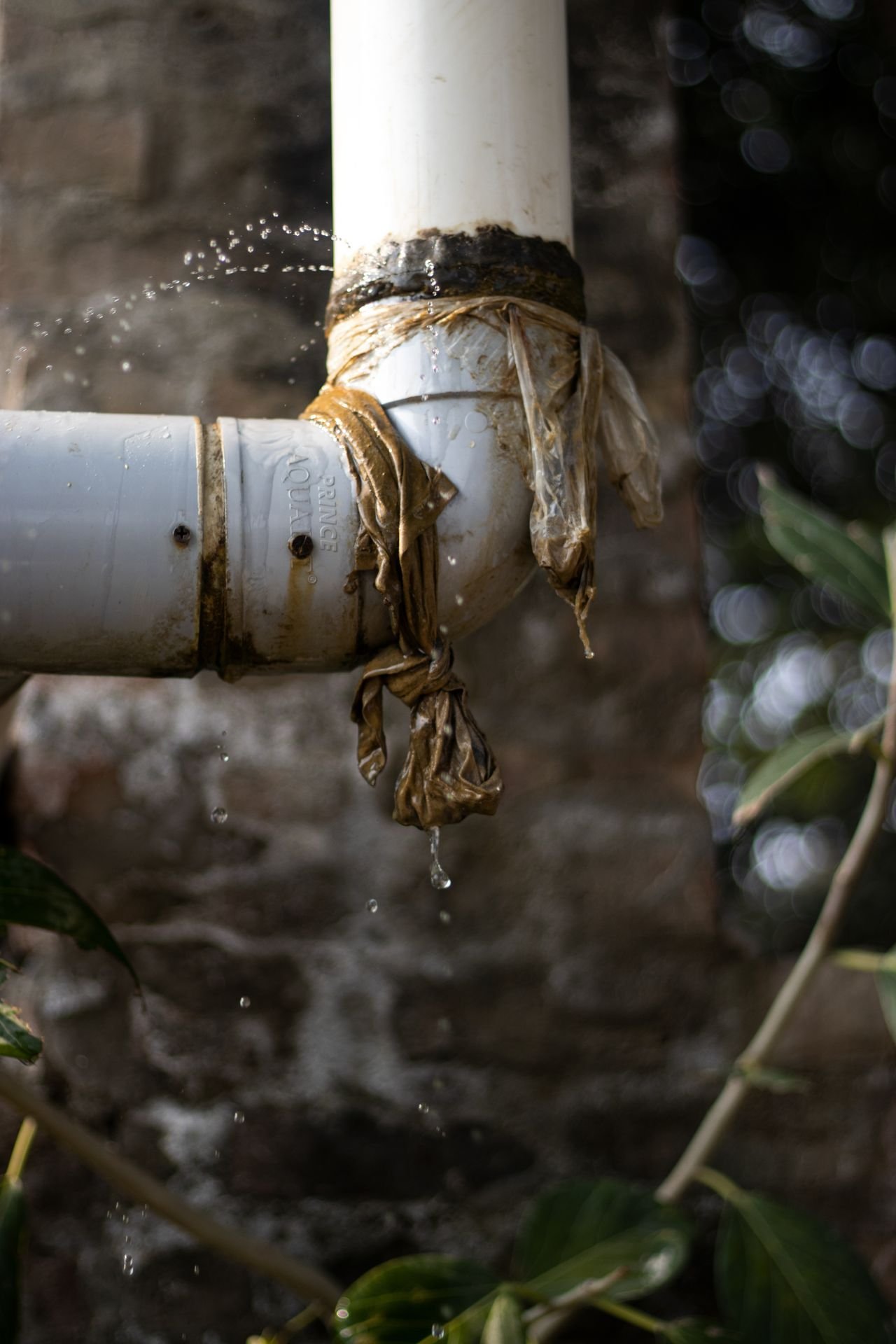 Burst pipe leaking water — turn off the stopcock before the plumber arrives