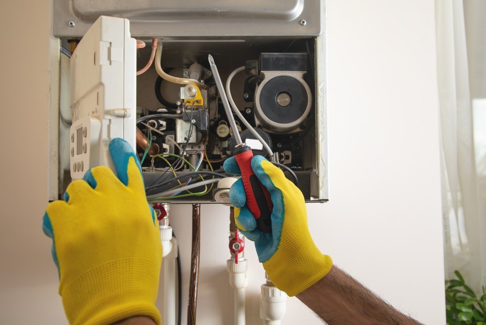 Plumber servicing a geyser for a residential customer